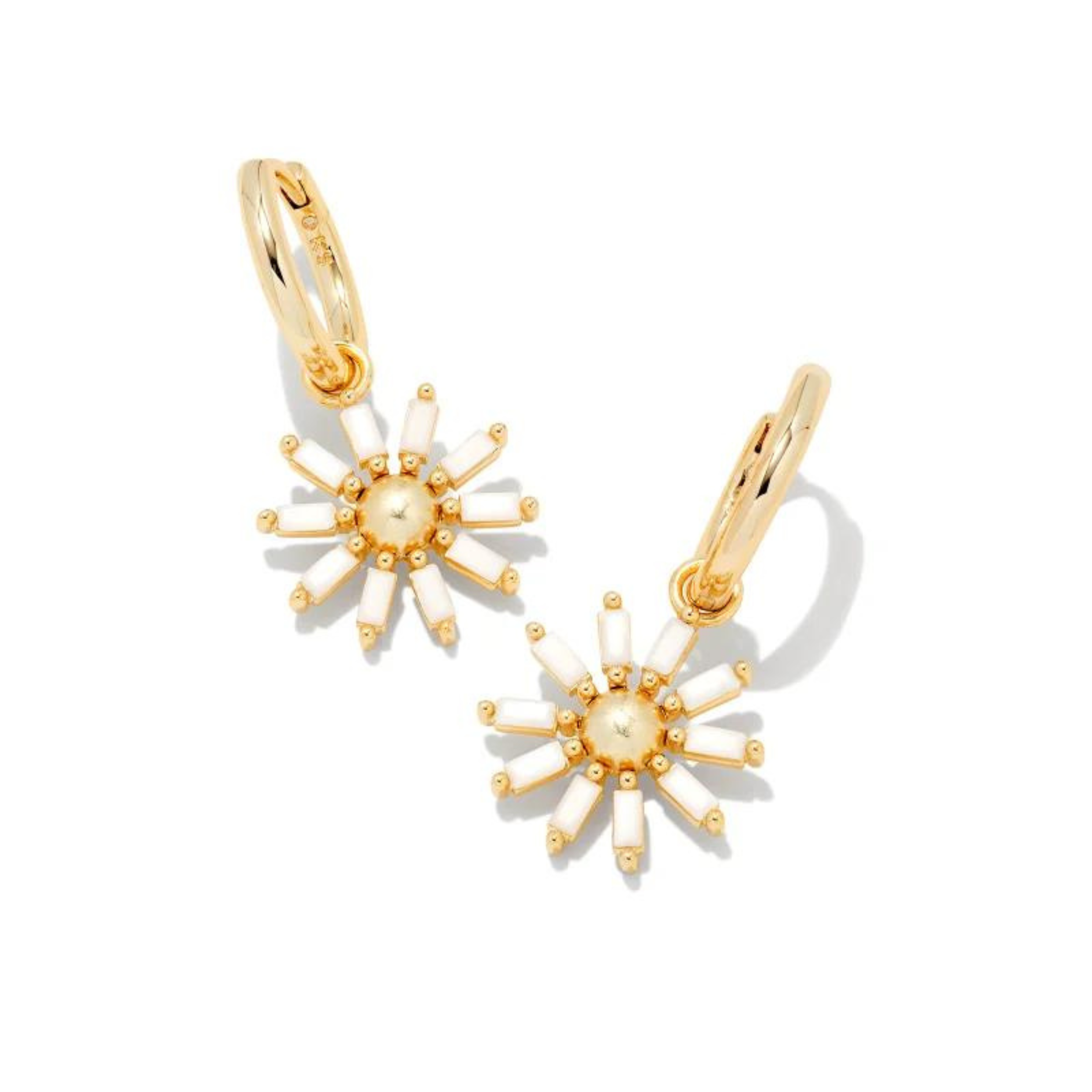 Gold flower hoop dangle earrings in white opaque glass, pictured on a white background.