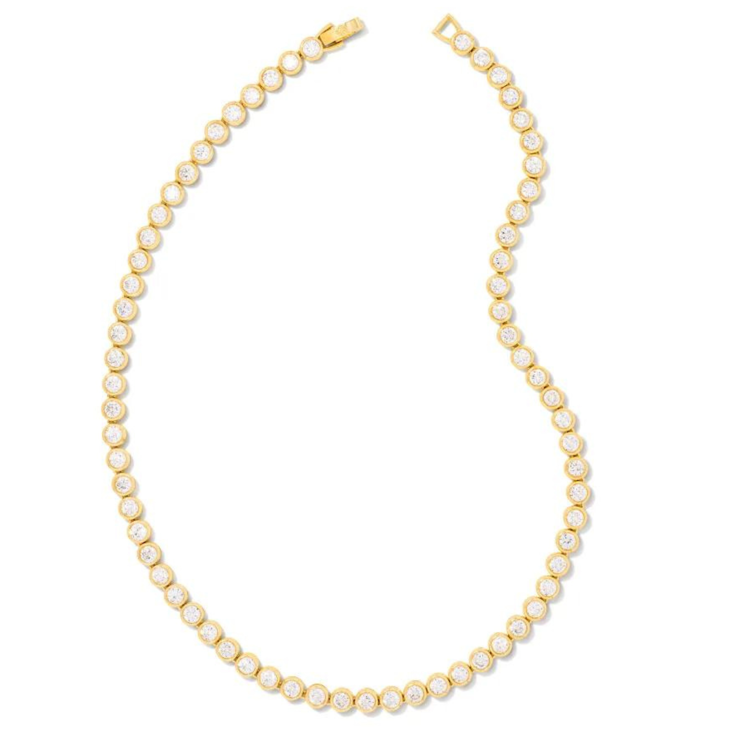 Gold tennis necklace with white crystals, pictured on a white background.