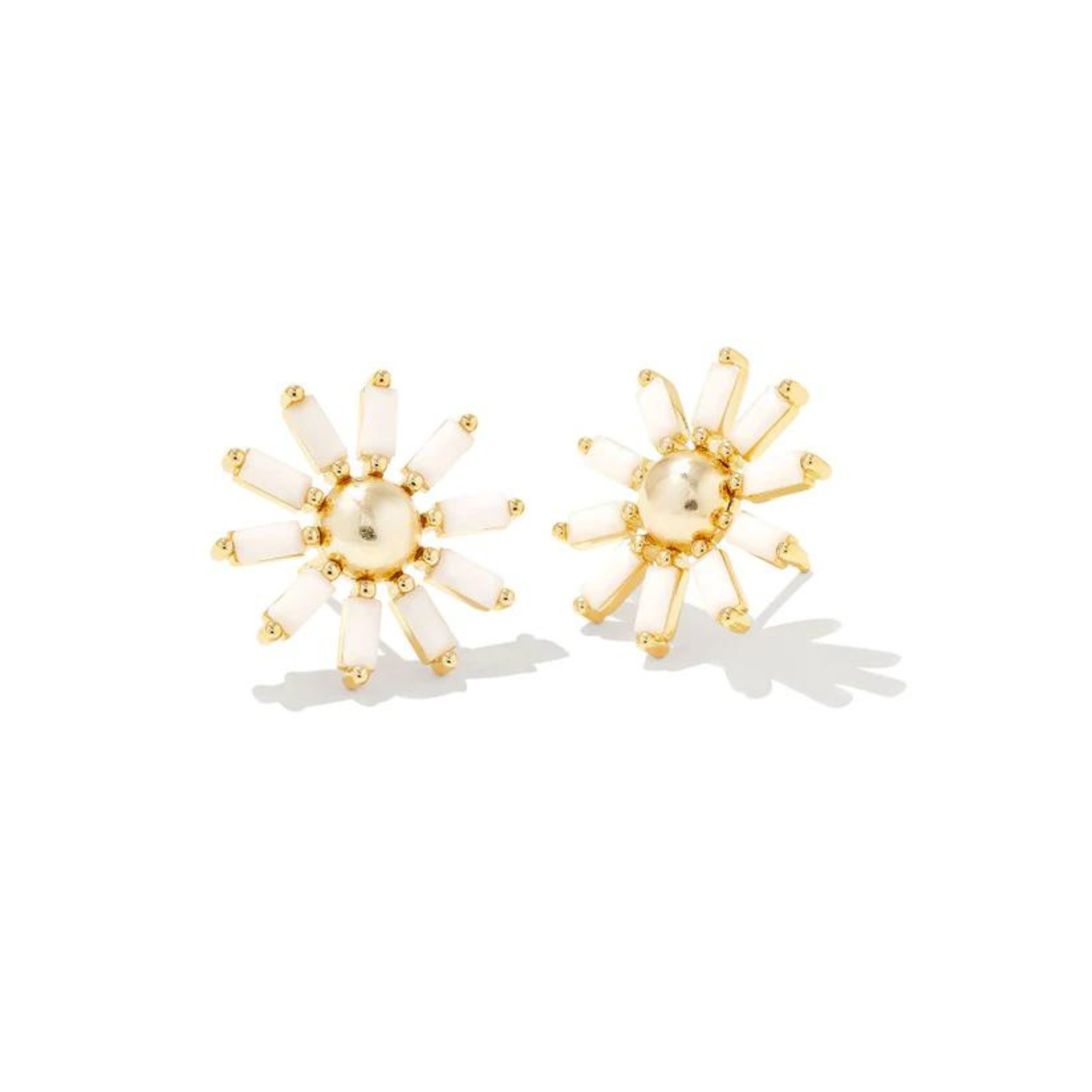 Gold daisy stud earrings with white opague class, pictured on a white background.