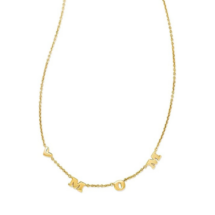 Gold necklace with the word mom spaced out and a heart, pictured on a white background.