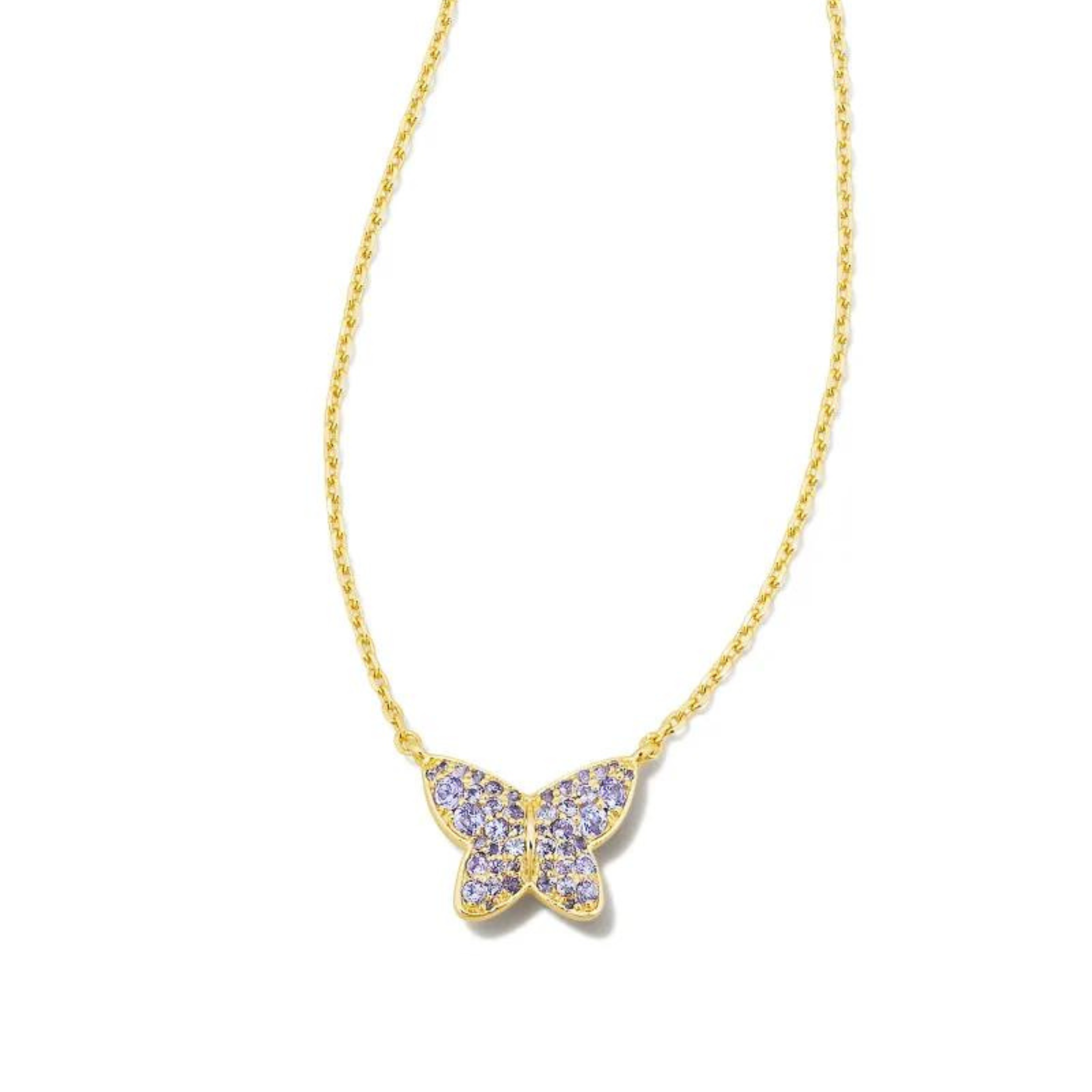 Gold necklace with a butterfly pendant with violet crystals, pictured on a white background.