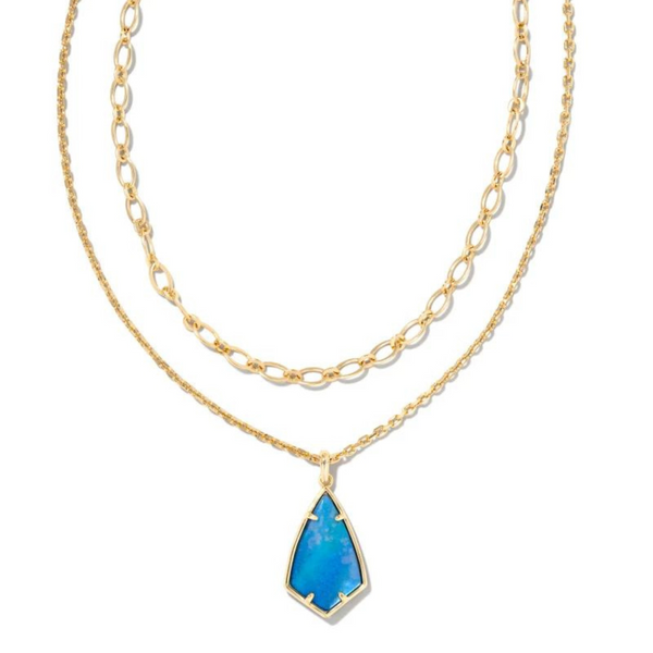 Gold multi strand necklace with dark blue mother of pearl pendant, pictured on a white background.