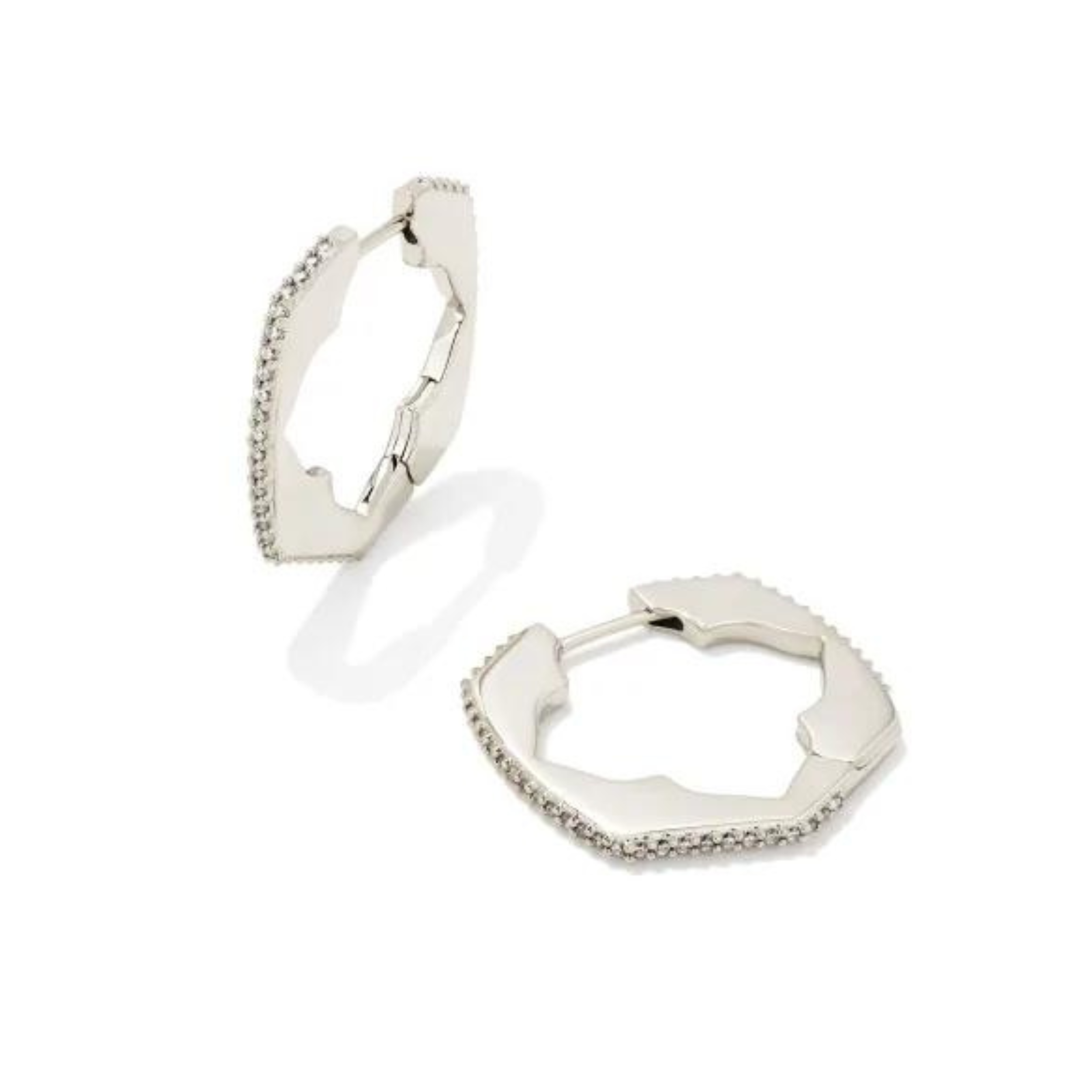 Silver huggie hoop earrings with Kendra Scott logo cut out surrounded by white crystals pictured on a white background.