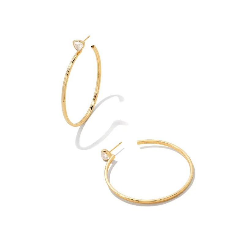 Gold hoop earings with white crystal stones at post of earring, pictured on a white background.