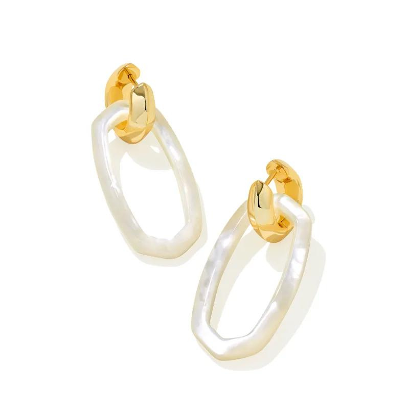 Gold huggie hoop earrings with mother of pearl dangle earring, pictured on a white background.