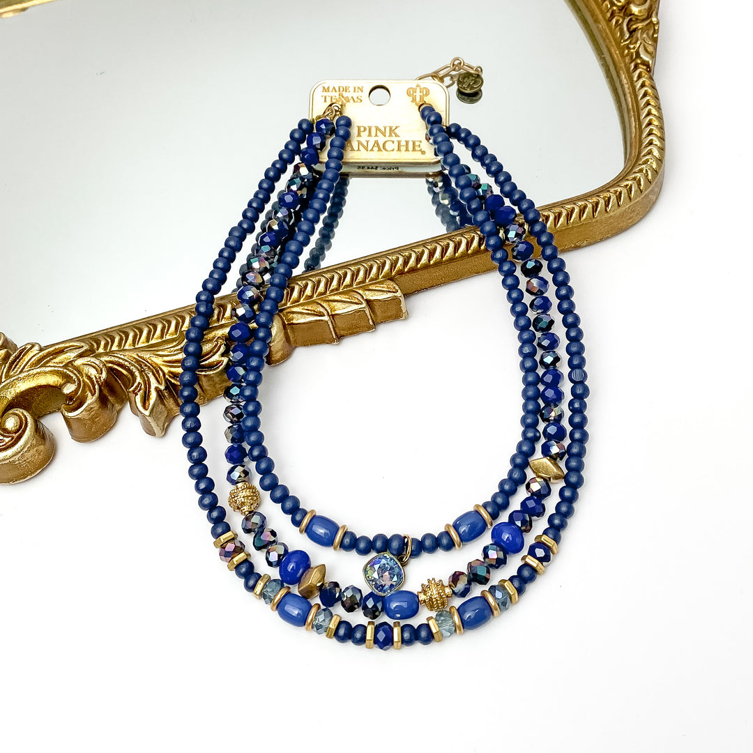 Pink Panache | Three Strand Beaded Necklace in Navy with Gold Tone Bead Spacers and Light Sapphire Shimmer Cushion Cut Crystal Drop - Giddy Up Glamour Boutique