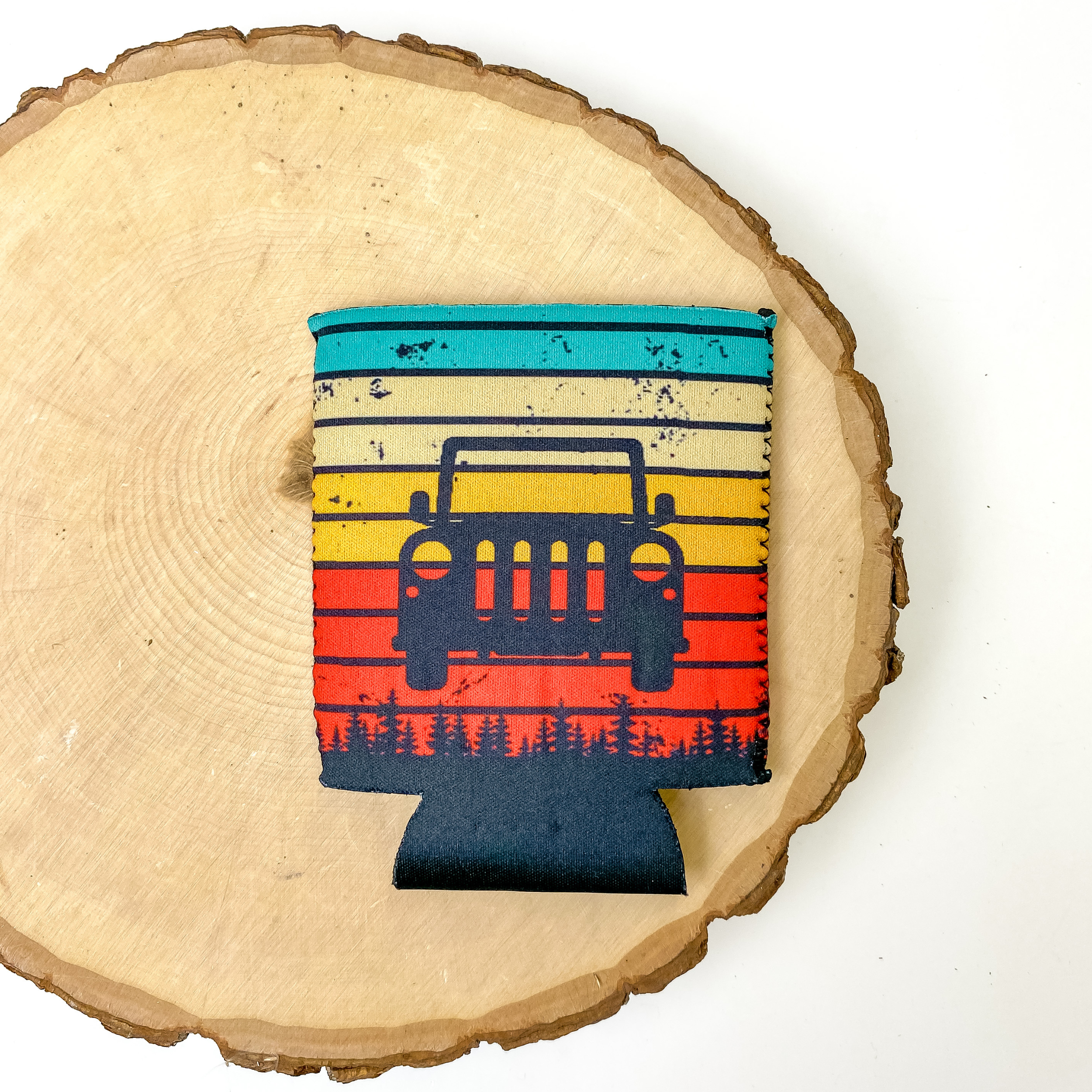 Koozie with red, ivory, and turquoise pattern with a car design. This koozie is pictured on a piece of wood on a white background.