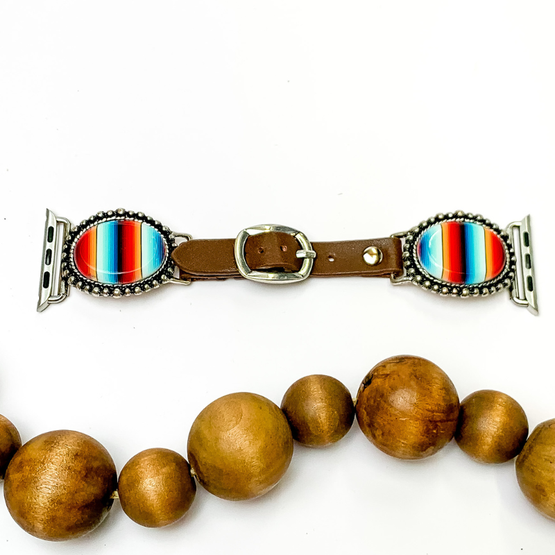 Pictured is a brown watch band with oval serape stones. They are pictured on the white background with wooden beads at the bottom.