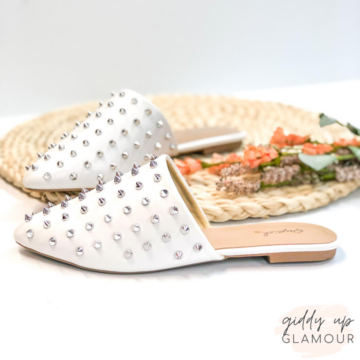 Uptown Girl Silver Spiked Slide On Mules in White. These cute shoes will give you an uptown flare! They include a silver spike embellished upper, a pointed toe, and a 0.25 inch high heel. Pair these shoes with any outfit for a fun look!