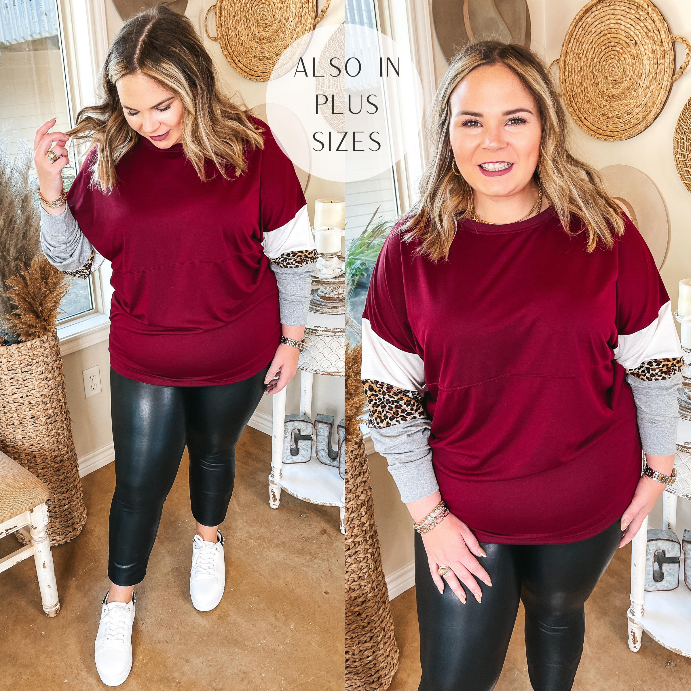 Model is wearing a maroon print block sleeve top. Model has it paired with faux leather leggings, white sneakers, and gold jewelry.