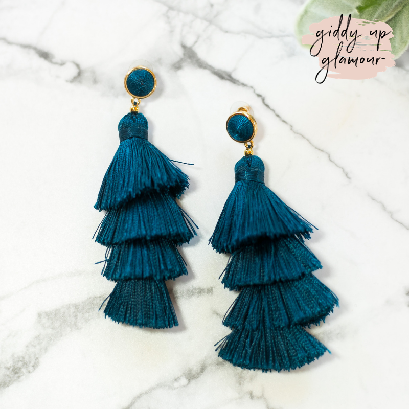 fun and flirty fast fashion long layered fringed tassel earrings with treaded top in dark teal blue on post back with gold accents