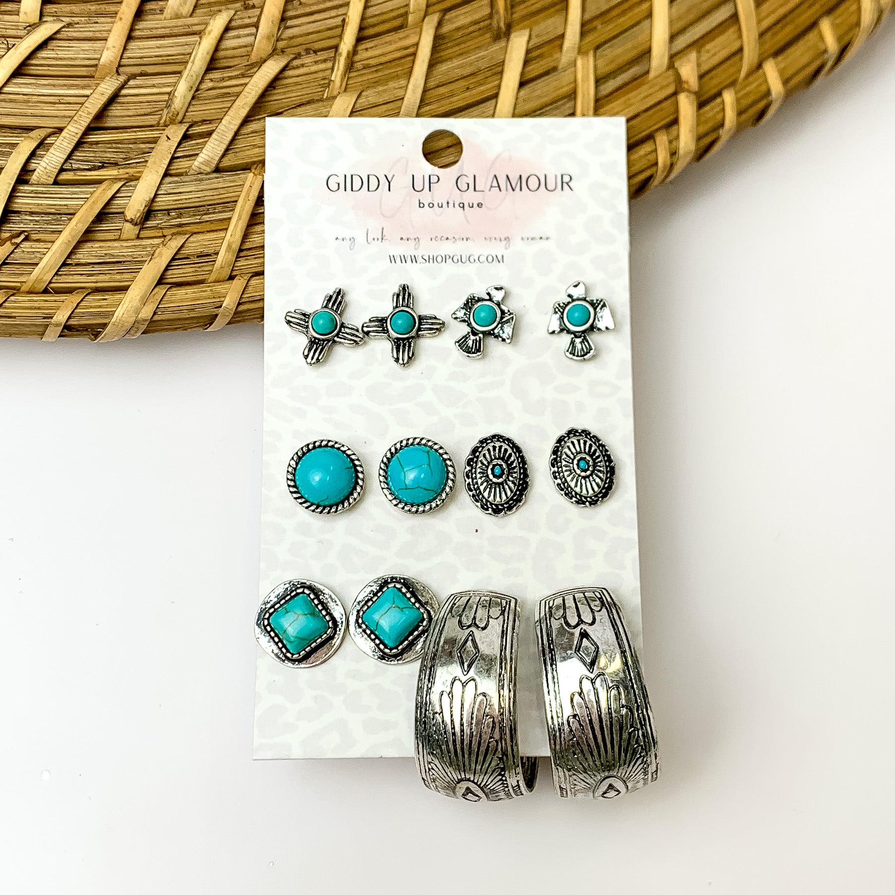 Set of six turquoise and silver designed stud earrings. On a white background with wood textured design in the top left.