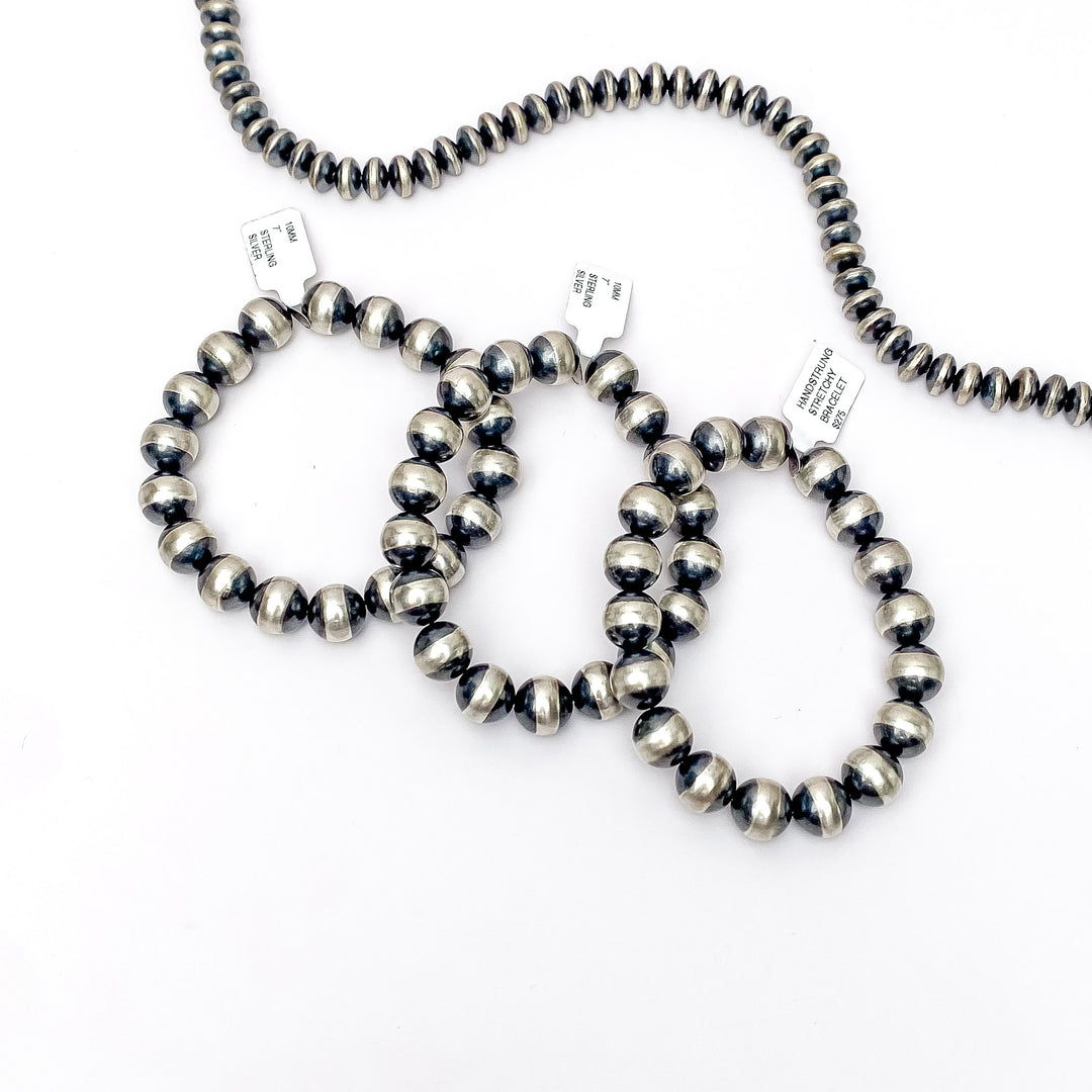 Centered is three genuine stretchy navajo pearl bracelets on a white background. 