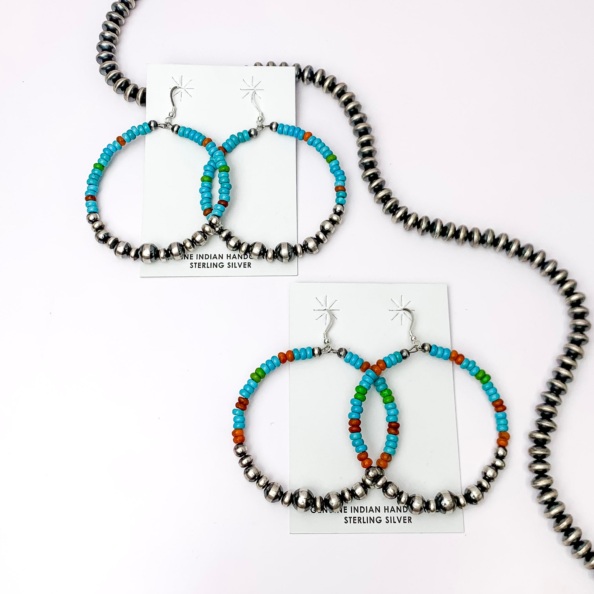 Centered in the picture is 2 pair of turquoise and navajo pearl beaded earrings on a white background. 