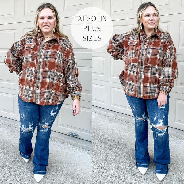 Model is wearing a rust brown plaid button up shacket with long sleeves and a collared neckline. Model has it paired with distressed trouser jeans, white booties, and gold jewelry.