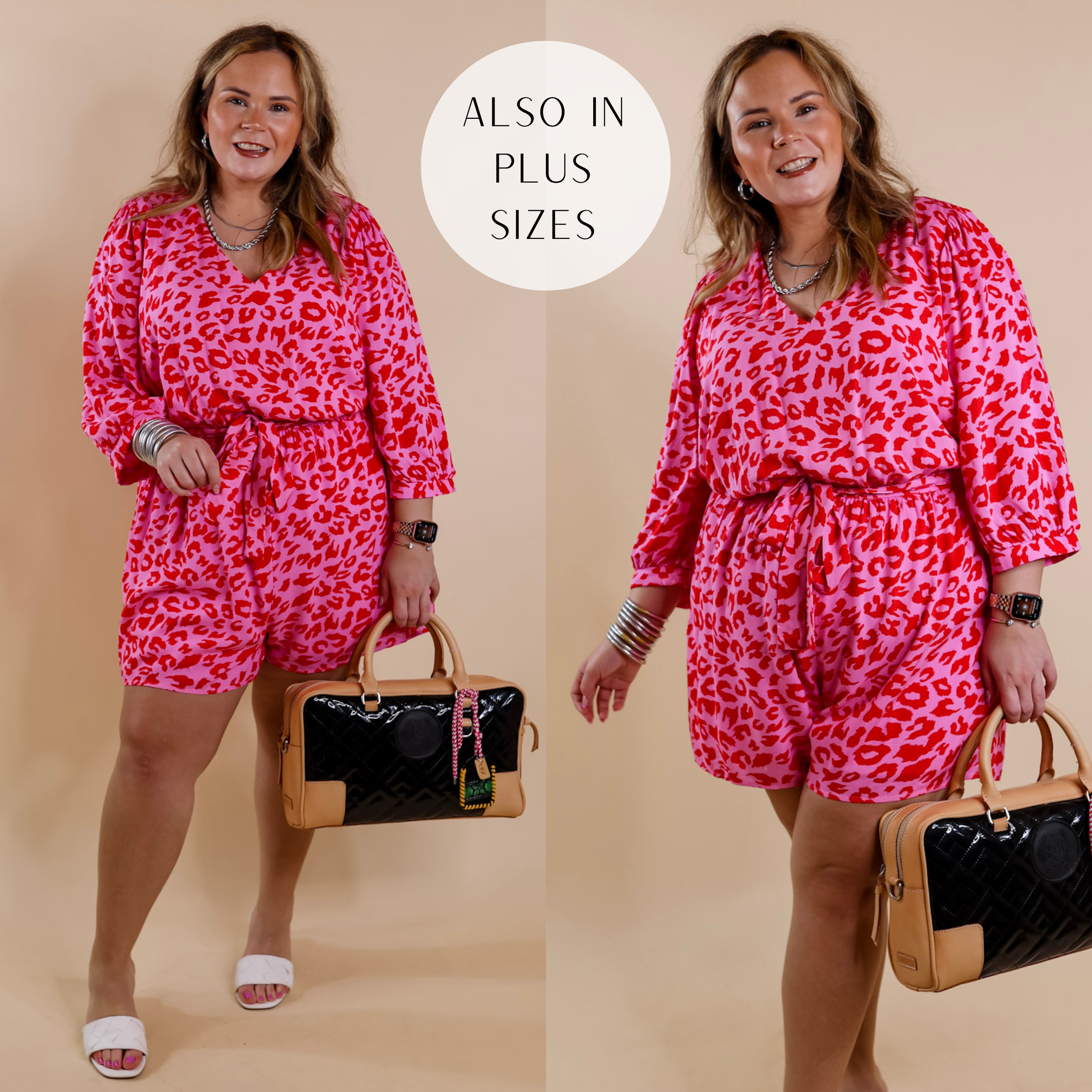 Model is wearing a pink romper with a red leopard print. This romper has a v neckline, a waist tie, and 3/4 sleeves. Model has this paired with white heels, silver jewelry, and a black Consuela purse.