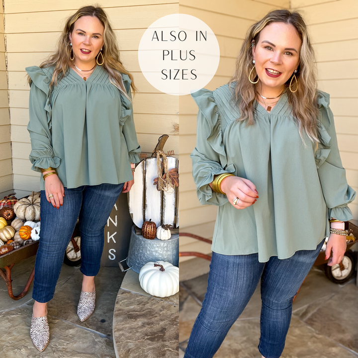 Model is wearing a long sleeve top with pleated and ruffle details. Model has it paired skinny jeans, leopard print mules, and gold jewelry.