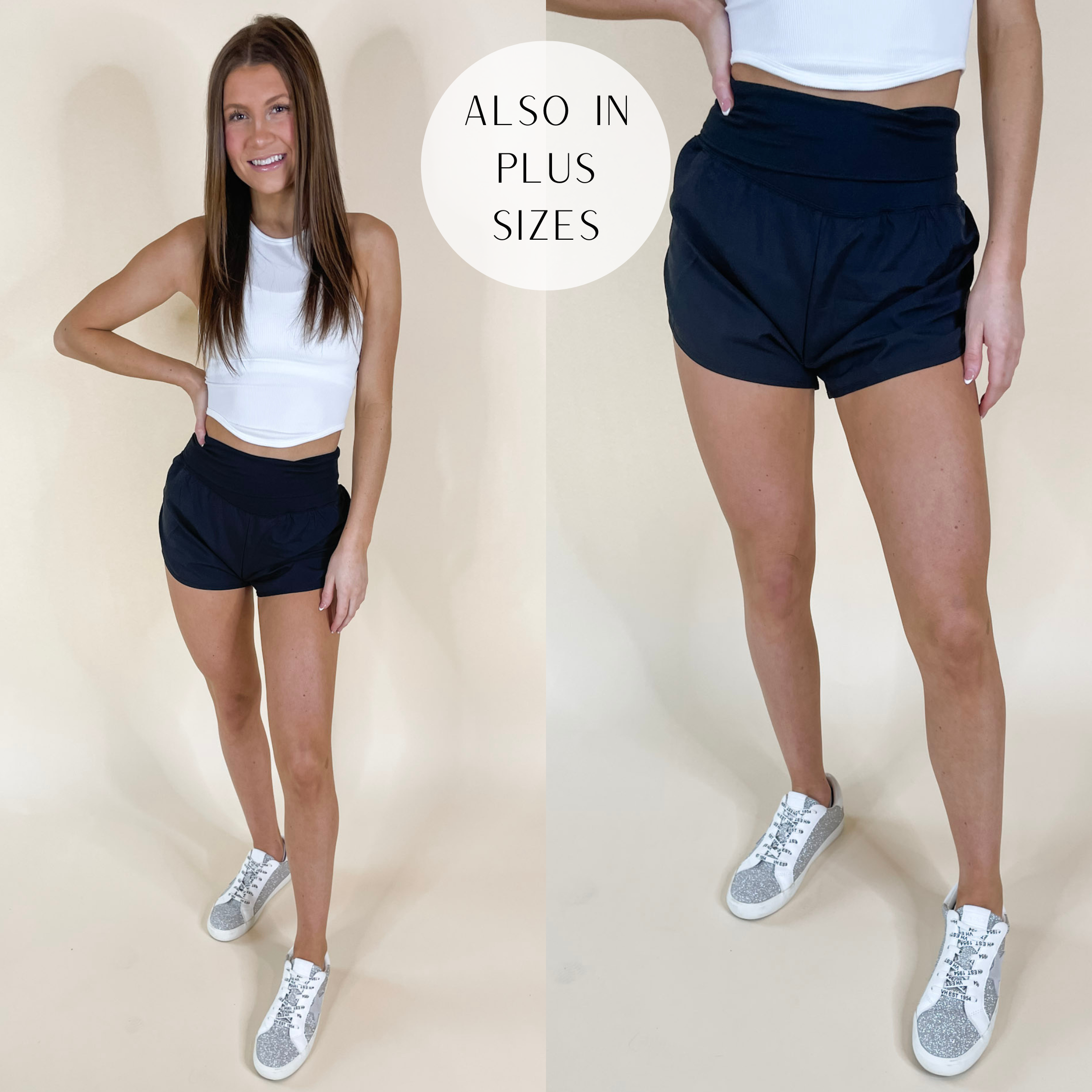 Model is wearing a pair of high waist running shorts that have a fold-over waist band. Model has these Black shorts paired with white sneakers and a white tank top.