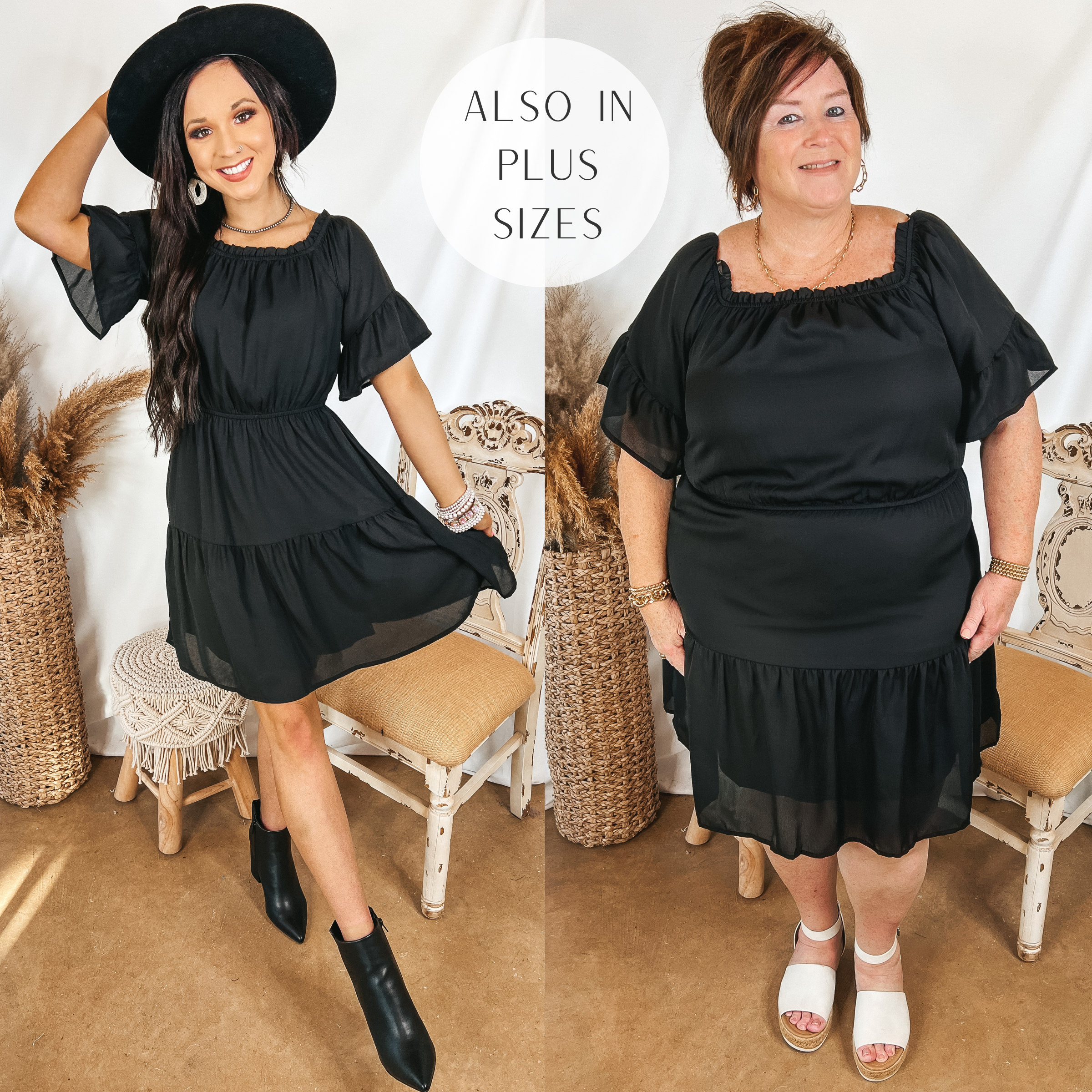 Models are wearing a black off the shoulder dress that is knee length. Size small model has it paired with black booties and a black hat. Plus size model has it paired with white sandals and gold jewelry.