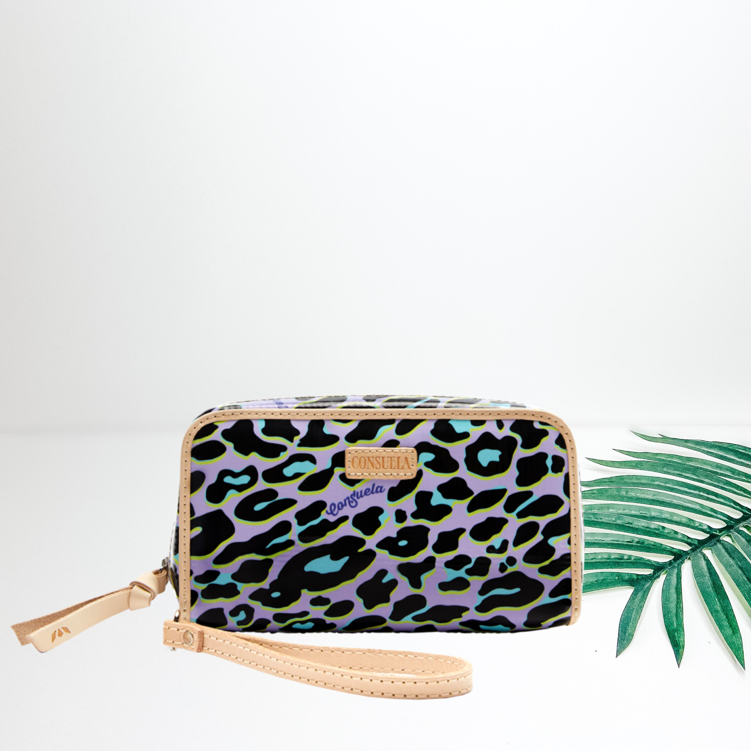 A purple and green leopard print wallet pictured on white background with a palm leaf.
