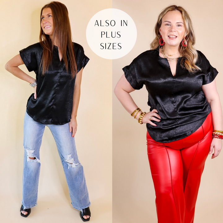 Model is wearing a black top with short sleeves and a notched v neckline. Model has it paired with distressed jeans, black heels. and gold jewelry.