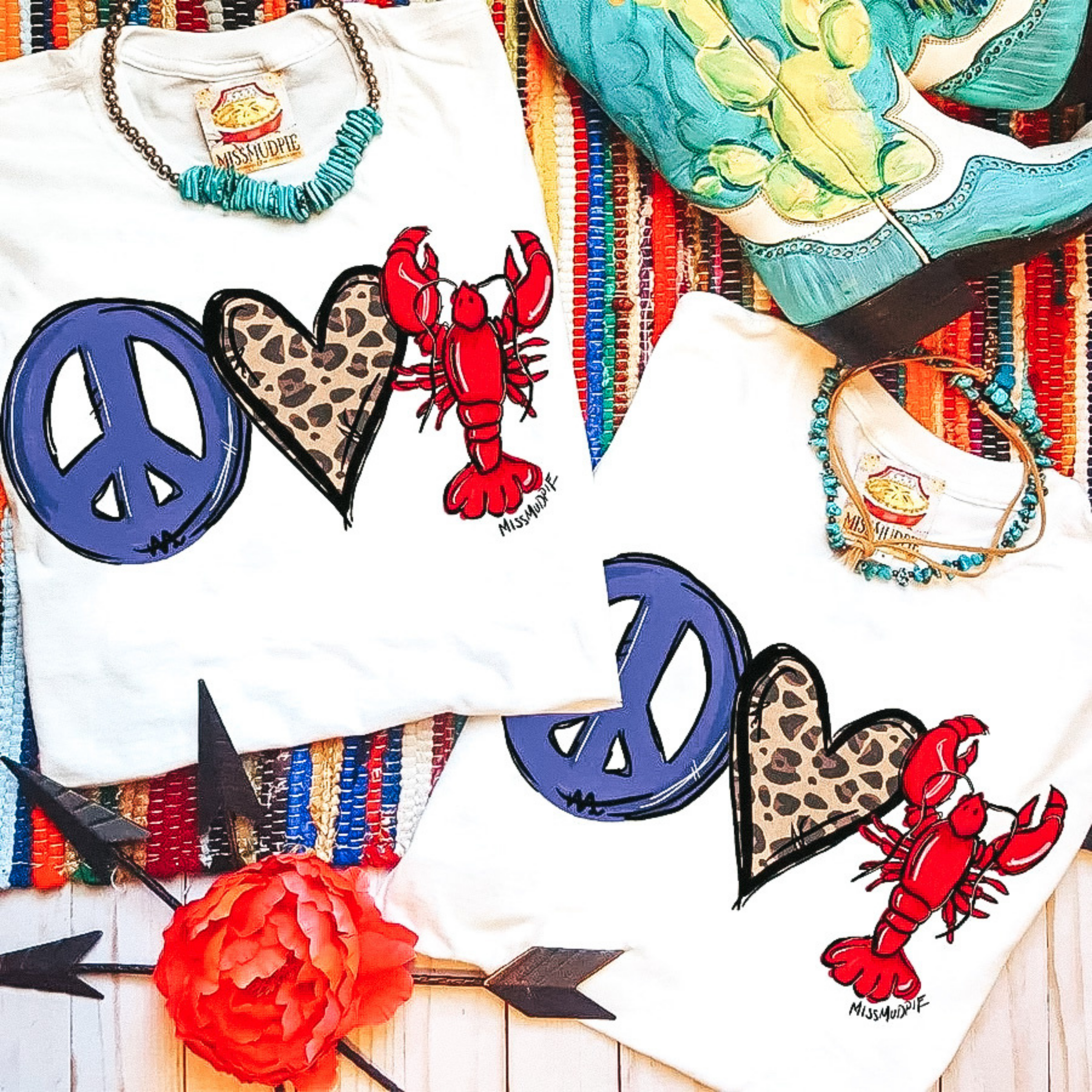 A white crew neck graphic tee that has a graphic of a peace sign , a leopard heart, and a crawfish.