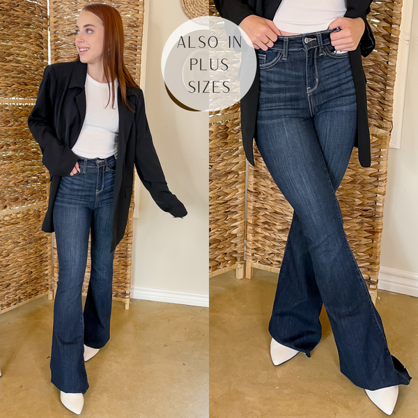Model is wearing a pair of dark wash flare jeans  with a raw hem. Model has it paired with white booties, a white tank top, and  a black blazer.