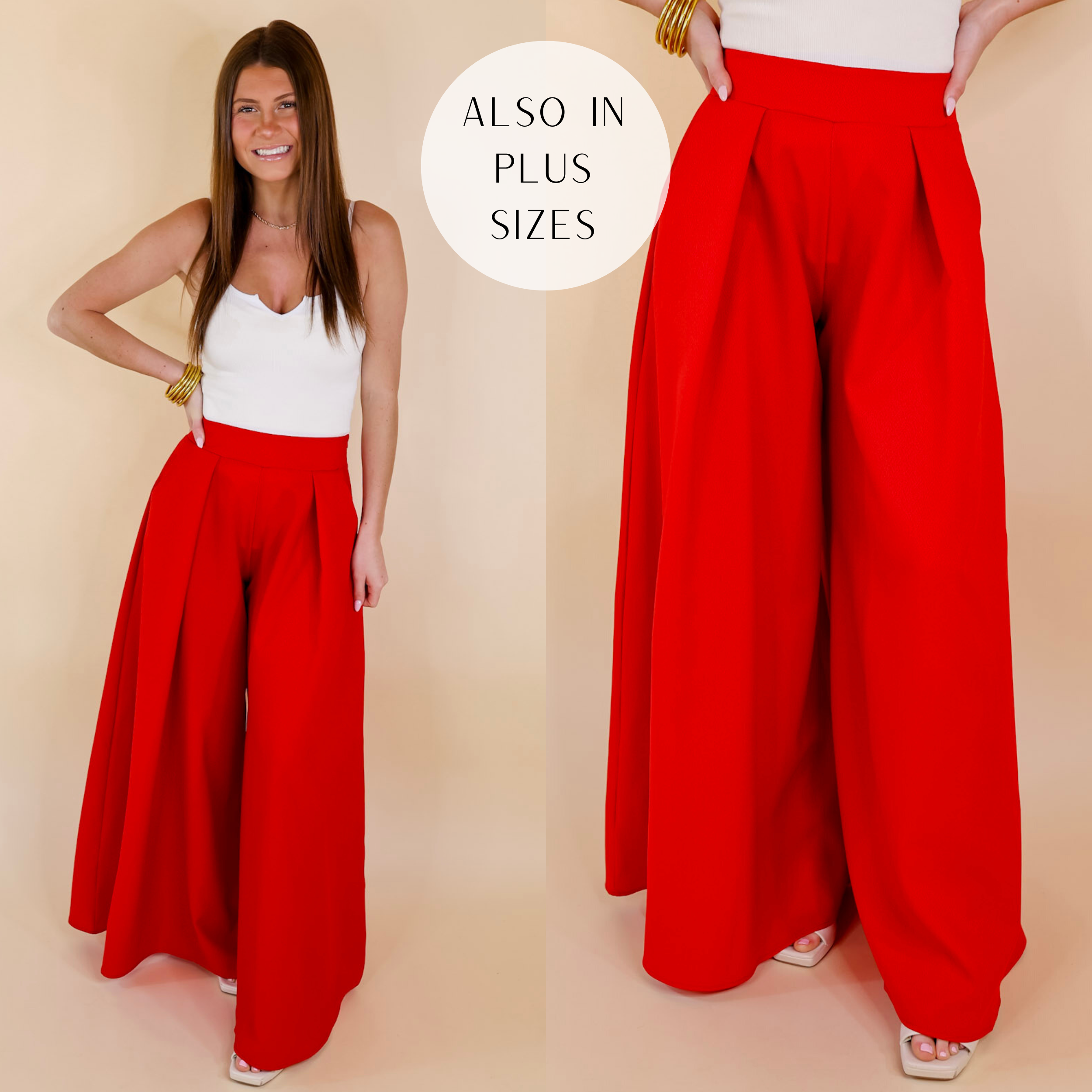 Model is wearing a pair of red pants with pleated detail on the front and a super wide leg. Model has it paired with a white tank top, ivory heels, and silver jewelry.
