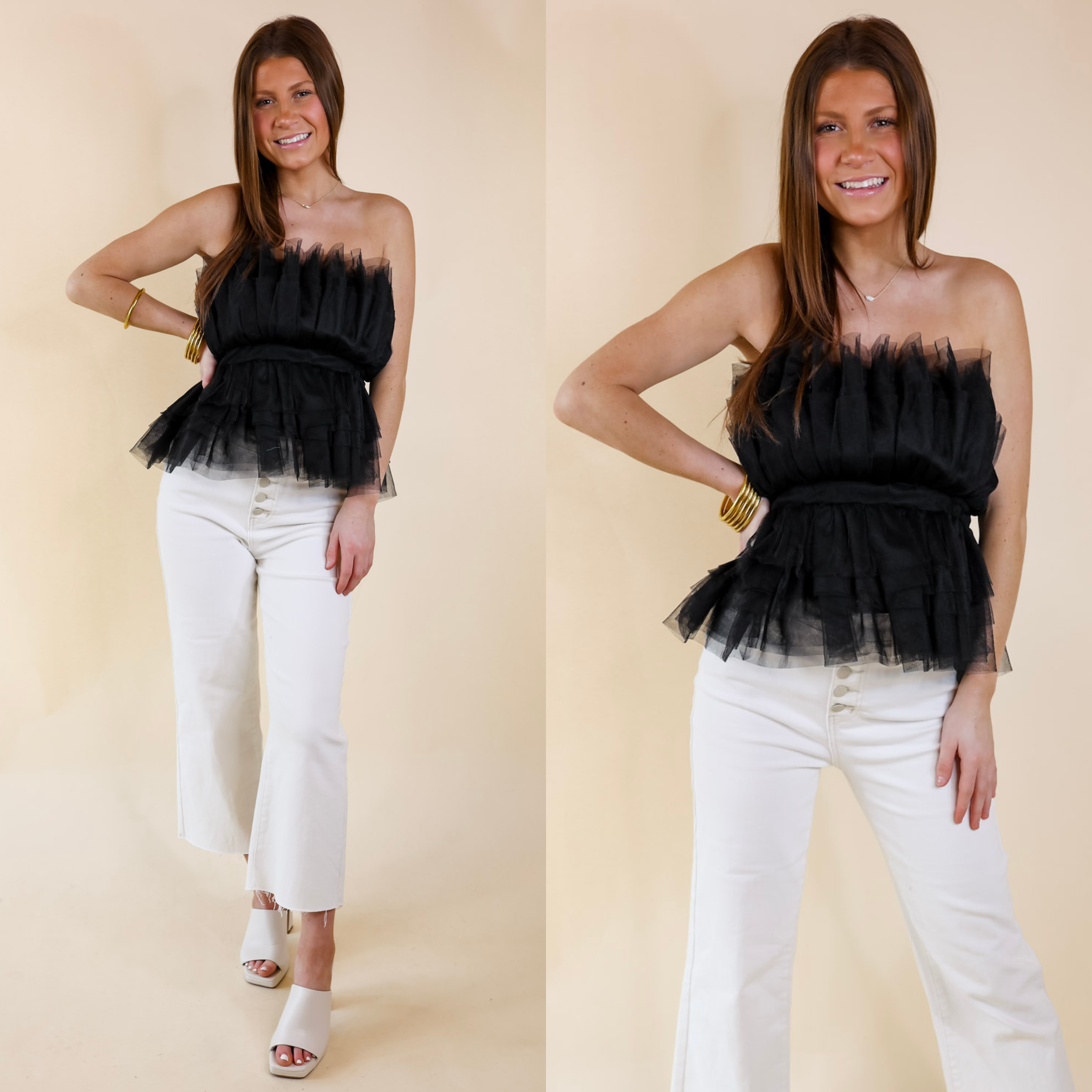 Model is wearing a strapless top made of tulle ruffles that is black. Model has this top paired with white jeans, ivory heels, and gold jewelry.
