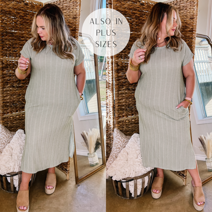 Model is wearing a green ribbed midi dress with short sleeves. Model has it paired with tan wedges and gold jewelry.