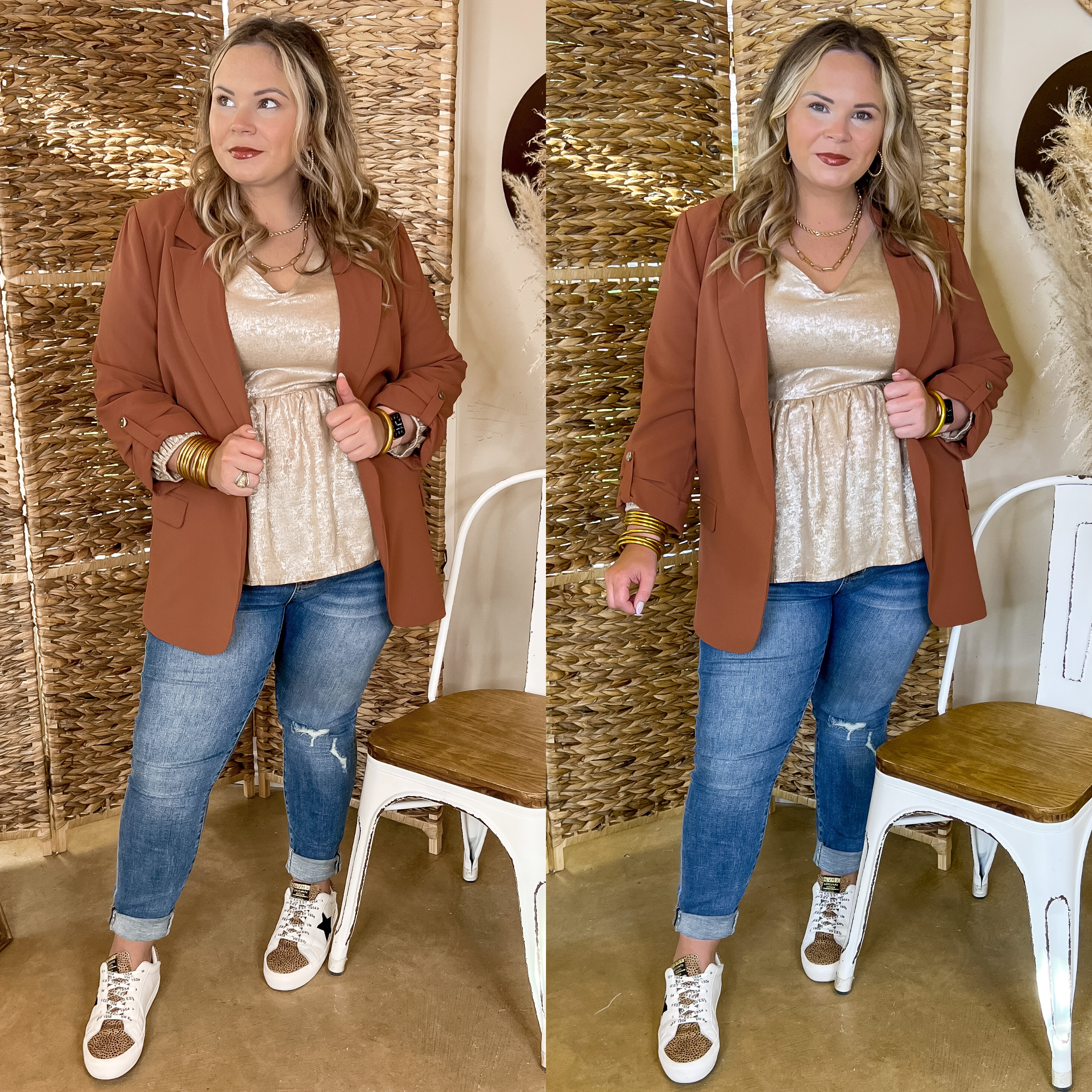 Model is wearing a rust brown blazer with 3/4 sleeves, a collared neckline, and an open front. Model has it on over a gold blouse with skinny jeans, leopard print sneakers, and gold jewelry.