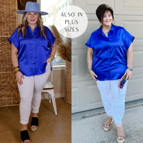 Model is wearing a button down collared short sleeve shirt in royal blue. Model has this top paired with white jeans, black espadrilles, gold jewelry, and a light blue "Lack of Color" hat.