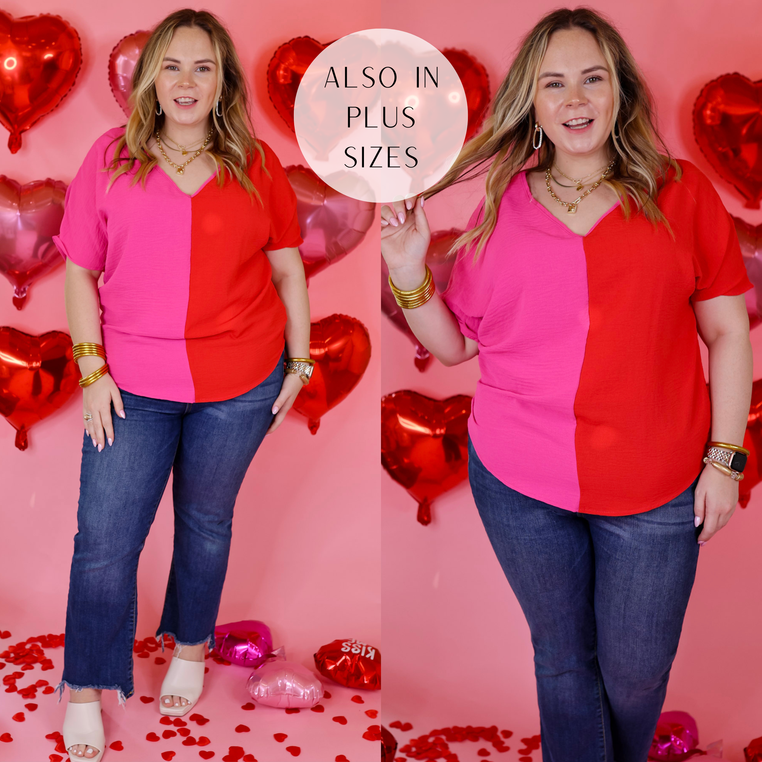 Model is wearing a short sleeve v neck top in fuchsia and red. Model has this top paired with straight leg jeans, white heels, and gold jewelry. Background is solid pink with red heart balloons. 