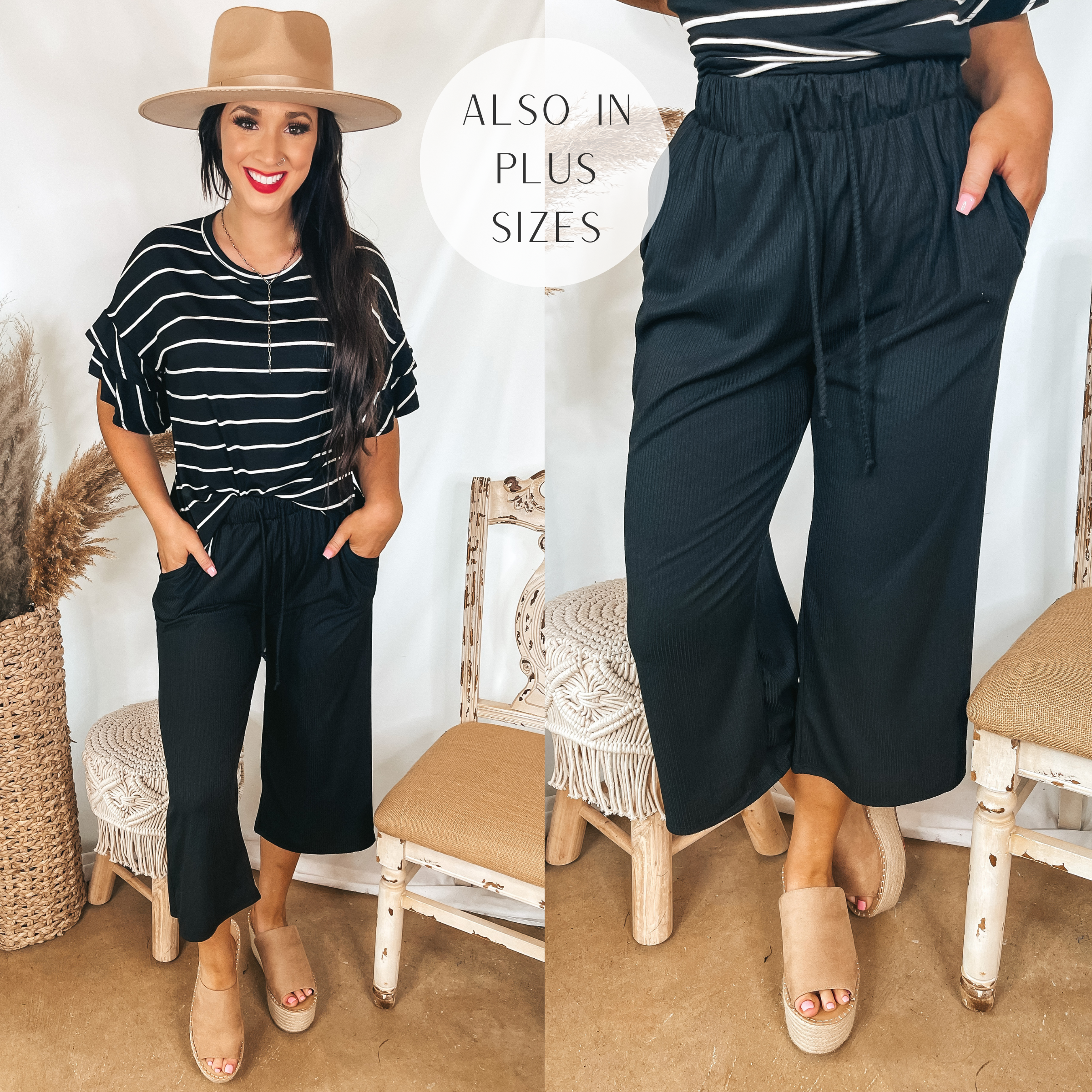 Model is wearing a pair of ribbed cropped pants that are black. Model has it paired with a black and white striped top, tan wedges, and a tan hat.