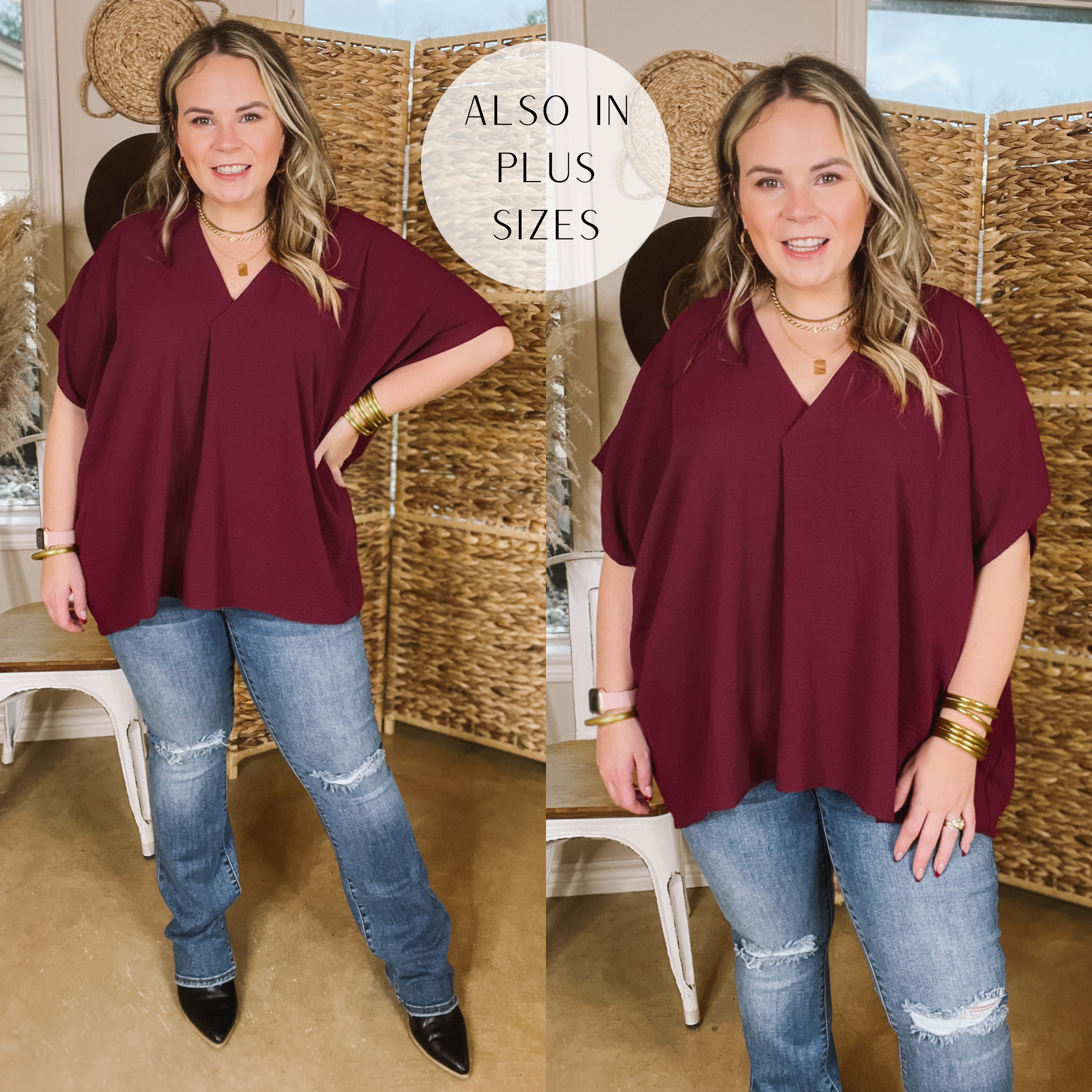 Model is wearing a short sleeve V neck top in maroon. Model has this top paired with bootcut jeans, black booties, and gold jewelry. 