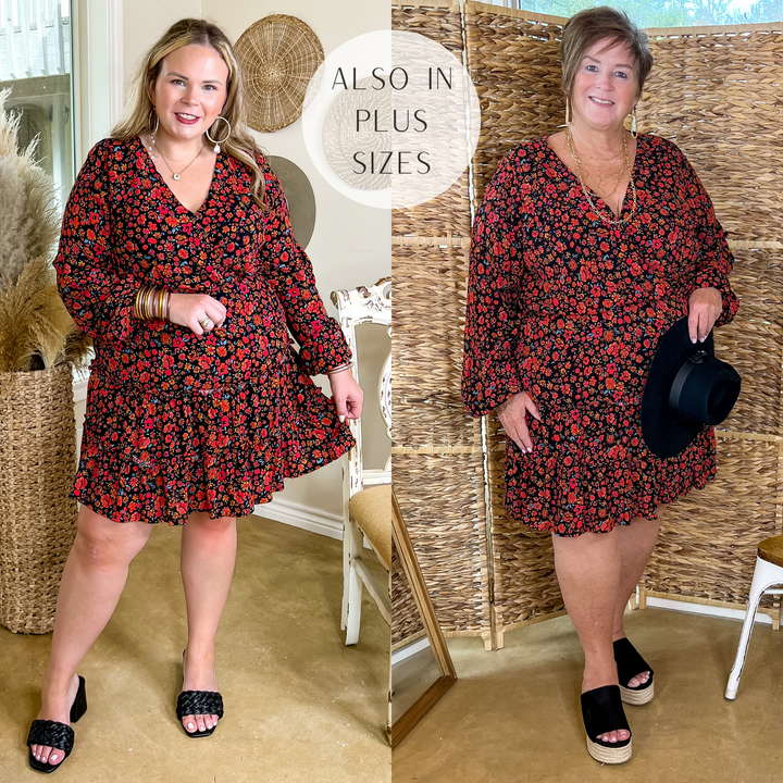 Model is wearing a black dress with long sleeves and a short, ruffle skirt. This dress has a red floral print on a black body. Model has it paired with black heels and gold jewelry.