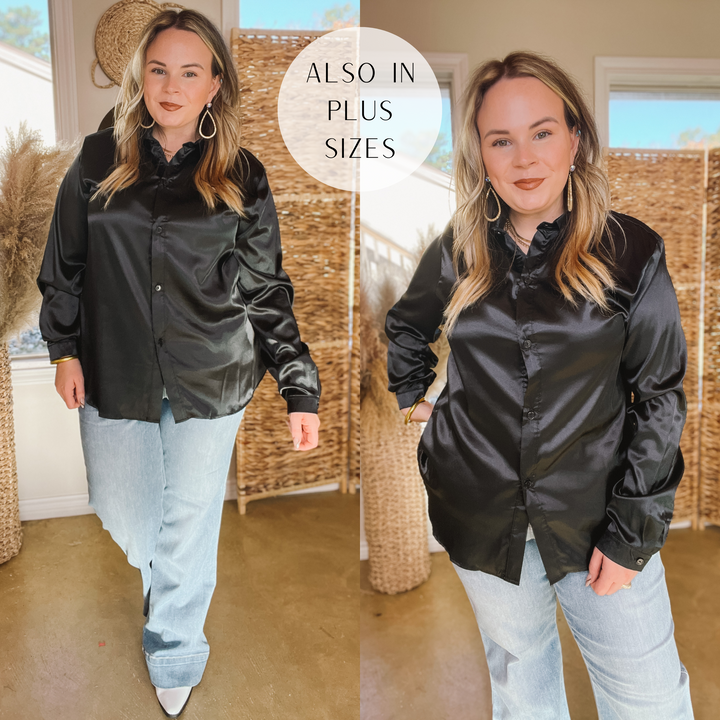 Model is wearing a black, satin, collared,  button down top. Model has this top paired with light-wash trouser jeans, white booties, and gold jewelry. Background is hues of brown and white. 