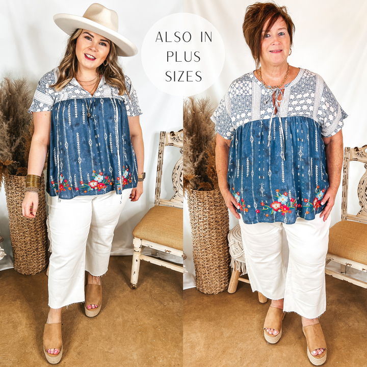 Models are wearing a navy blue top that has an ivory print and floral embroidery. Both models have it paired with white cropped jeans, tan wedges, and gold jewelry.