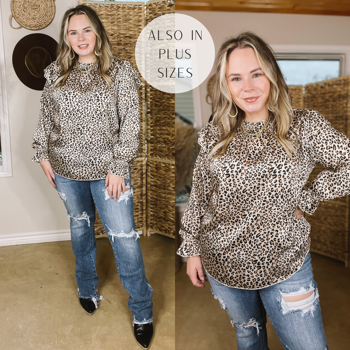 Model is wearing a leopard long sleeve shirt with ruffles long the shoulders.  Model has it paired with black booties, distressed jeans, and gold jewelry. 