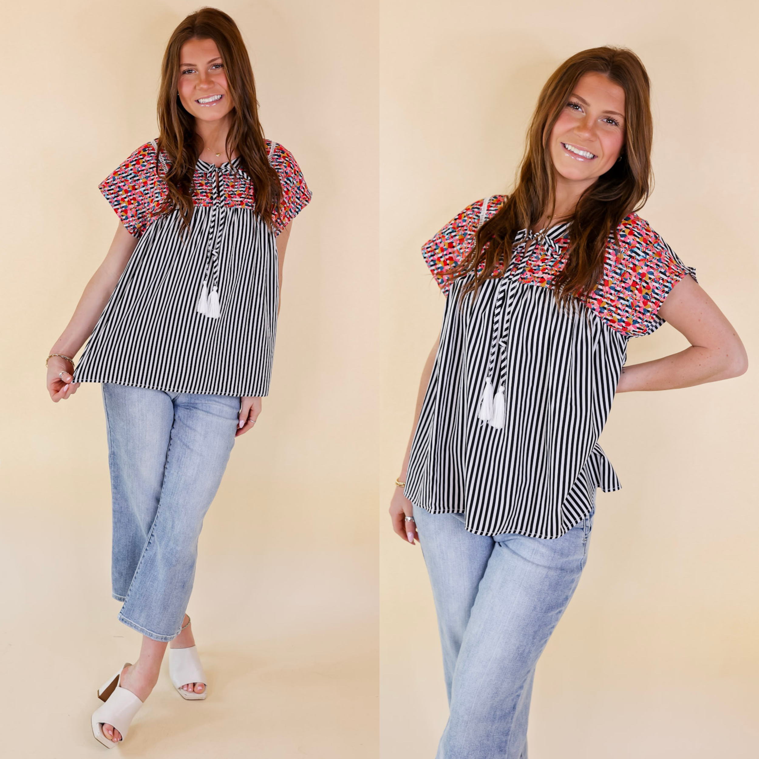Model is wearing a black and white striped top with floral embroidery. Model has it paired with light wash jeans, ivory heels, and gold jewelry.
