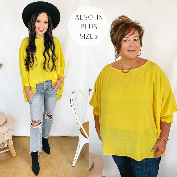 Models are wearing an oversized yellow top with smocked wrists. Size small model has it paired with light wash jeans, black booties, and a black hat. Plus size model has it paired with dark wash jeans and gold jewelry.