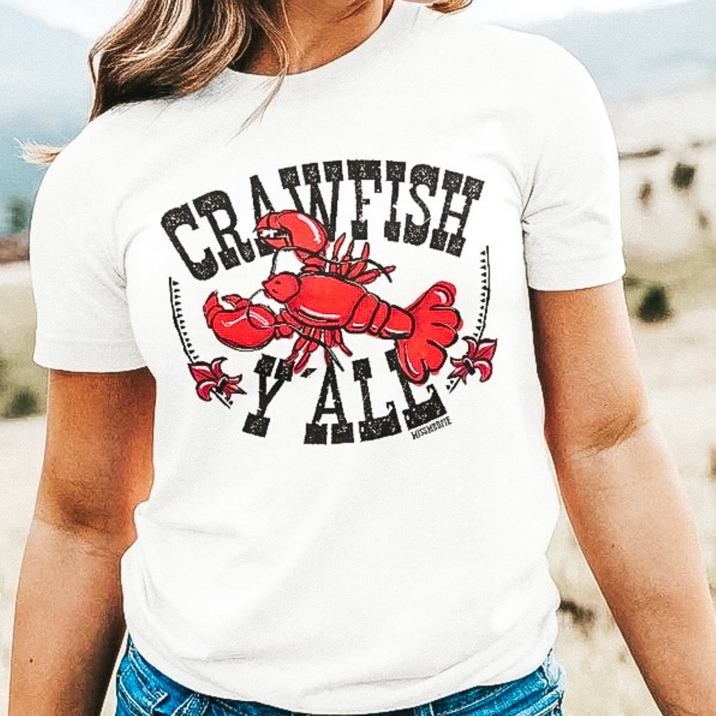White short sleeve tee shirt with crew neckline. The graphic  has a sideways crawfish that says " Crawfish Y'all."