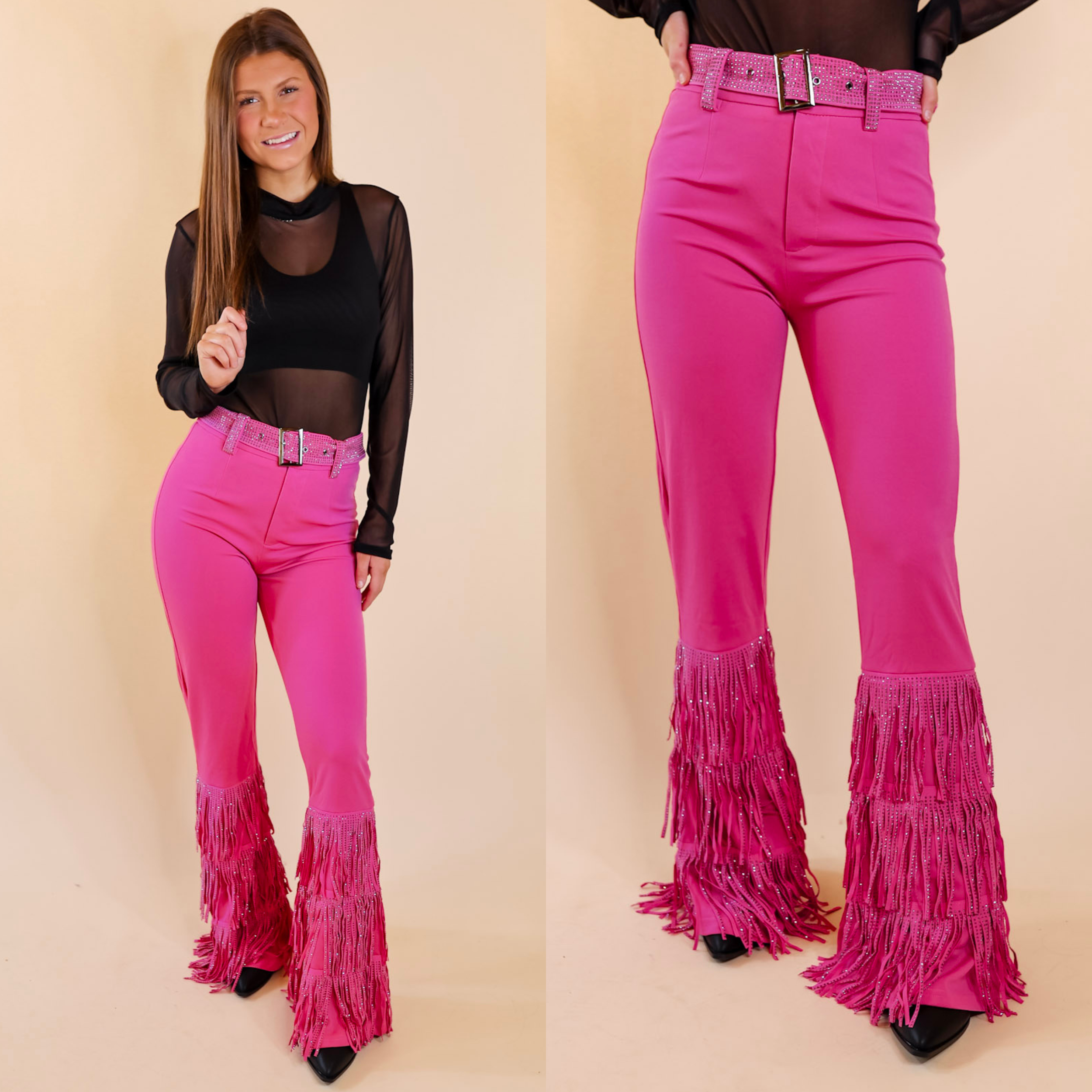 Model is wearing a pair of hot pink bell bottom pants with a crystal belt and crystal fringe from the knee down. Model has it paired with black booties, a black bodysuit, and silver jewelry.