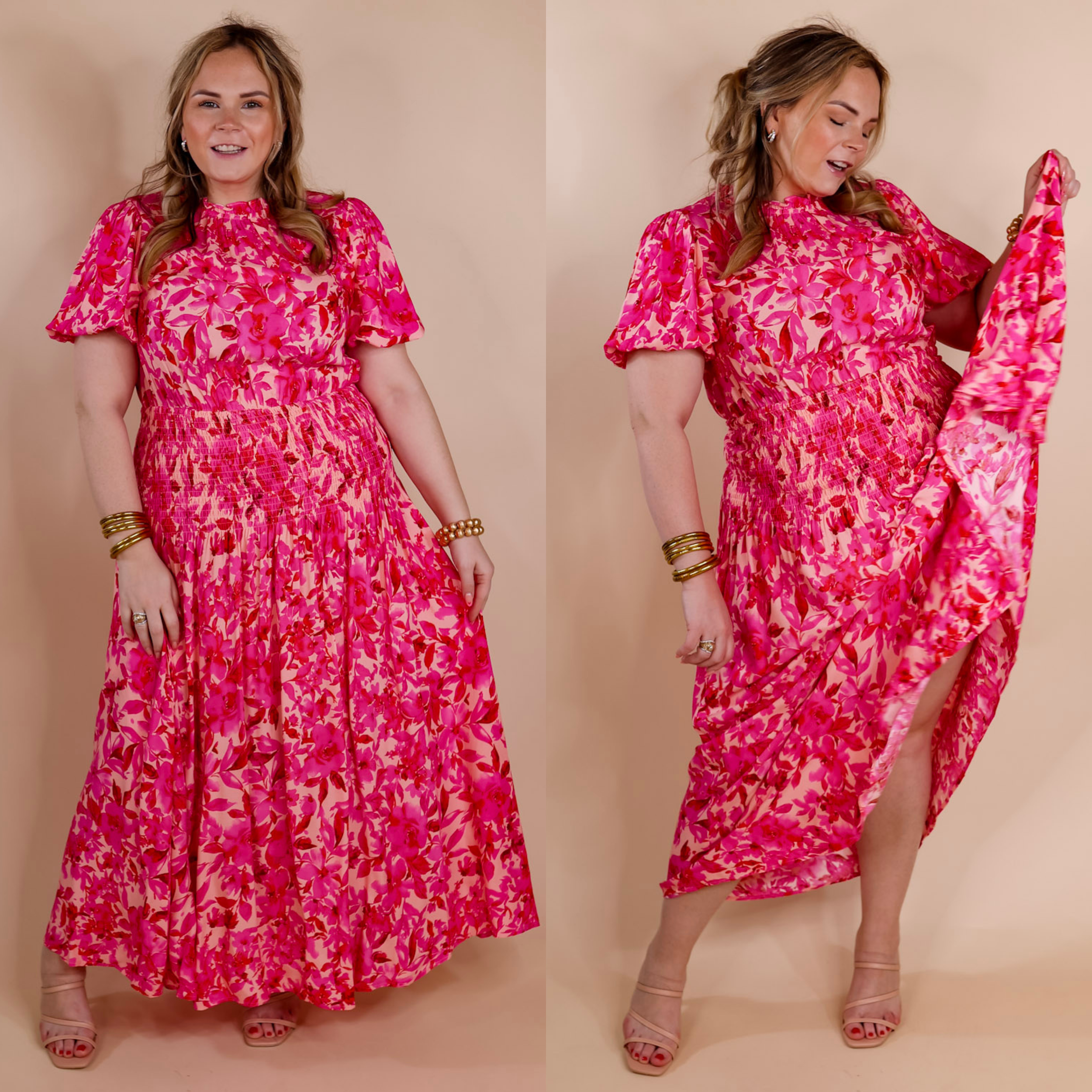 Model is wearing a pink floral maxi dress with short sleeves, a smocked waistline, and a high ruffle neck. Model has it paired with gold jewelry and nude heels.