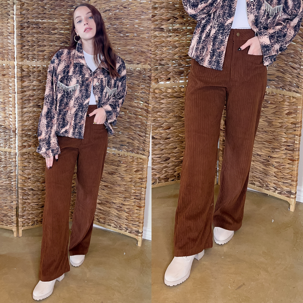 Model is wearing a white bodysuit with a leopard jacket with crystal fringe detailing on the pocket. Paired with the jacket is brown, wide leg, corduroy pants with cream boots and gold jewelry