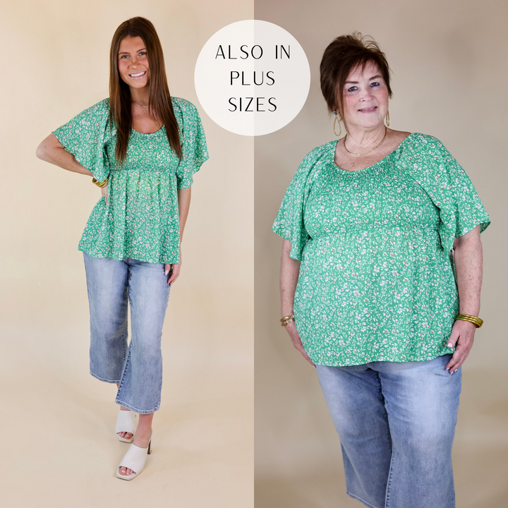 Models are wearing a smocked blouse with flowy short sleeves and flowy bottom. The top has a white and orange floral print. Both models have it paired with ivory heels, light wash jeans, and gold jewelry.