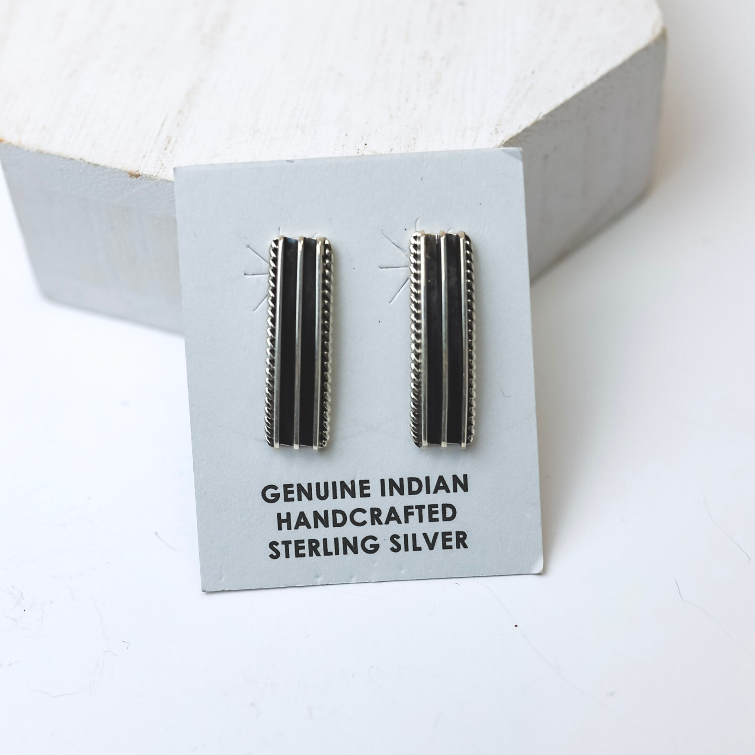 Mark Yazzie Navajo Handmade Sterling Silver Rectangle Post Earrings are centered in the middle of the picture on white background. 