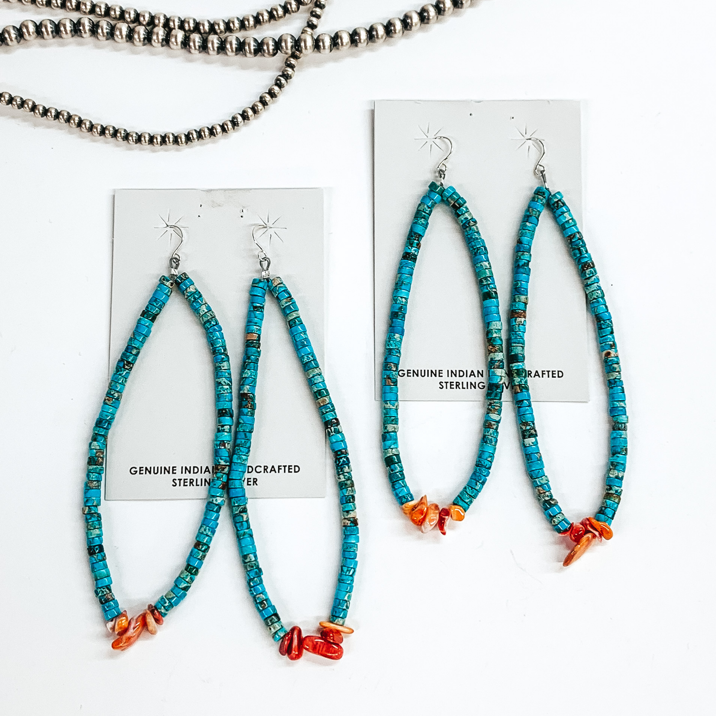 Open, turquoise beaded earrings with spiny oyster beads at the bottom of the earrings. these earrings are pictured on white cardstock on a white background. 