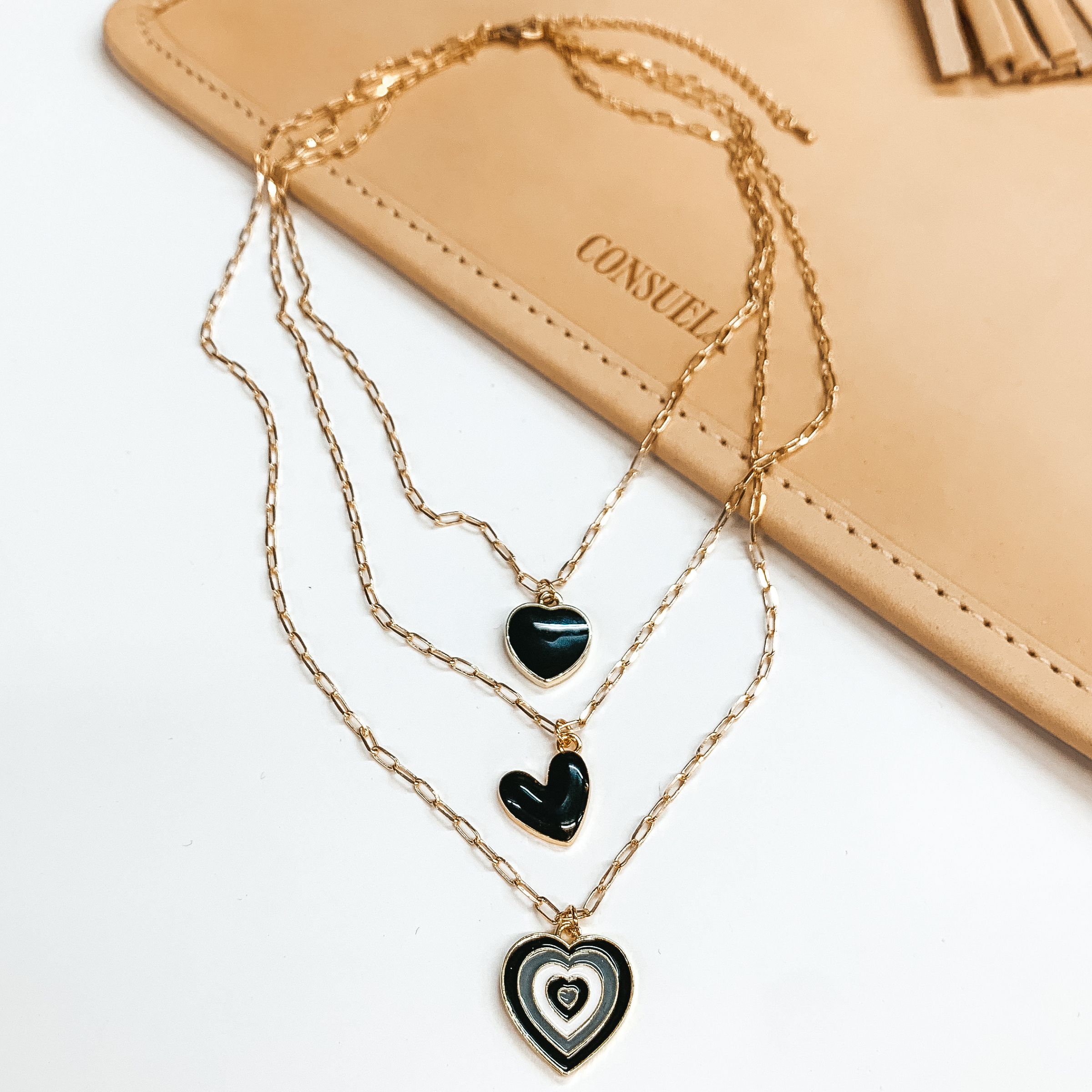 Three Strand Gold Multi Chain Necklace with Black and White Heart Charms