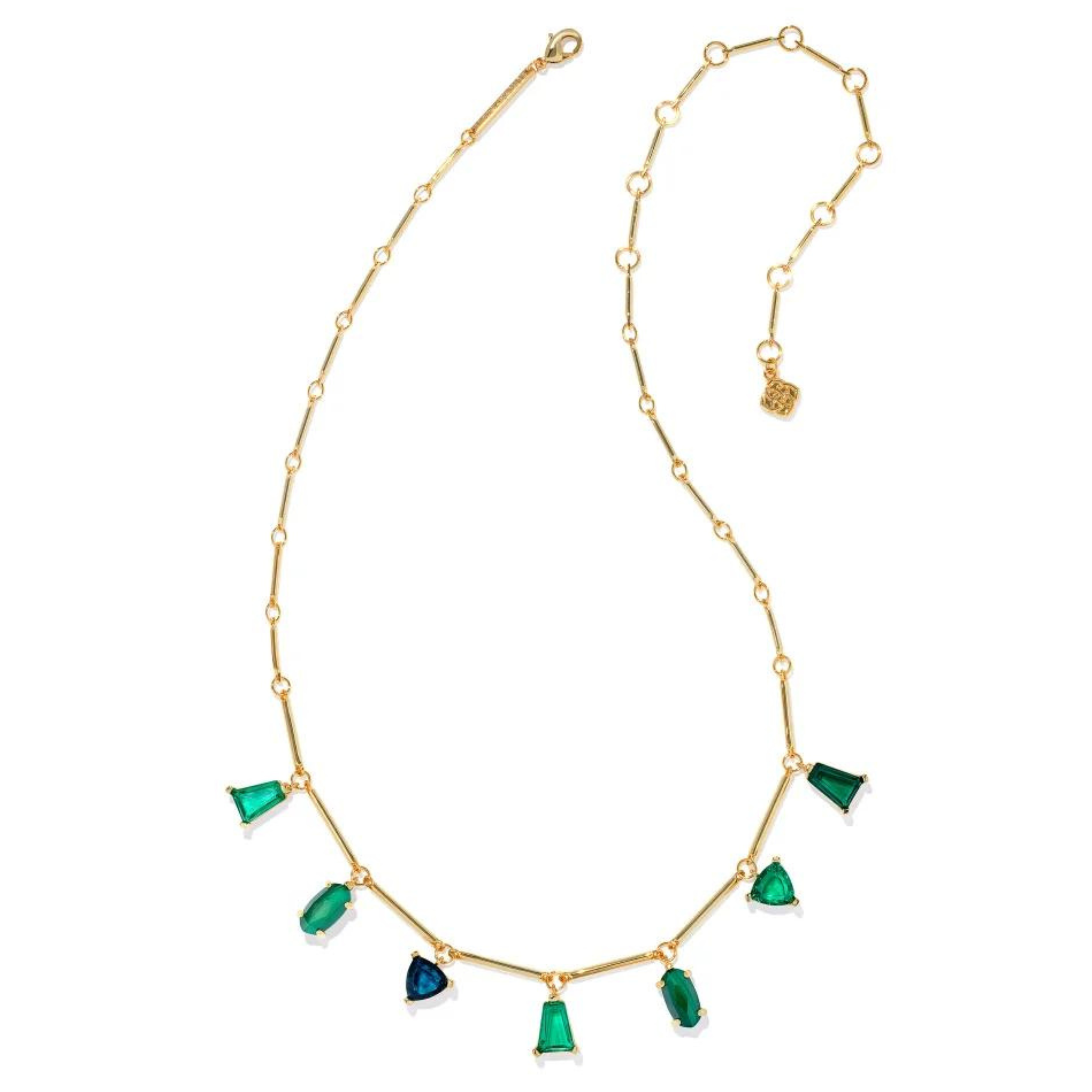 Gold chain necklace with emerald crystal charms in different shapes. This necklace is pictured on a white background. 